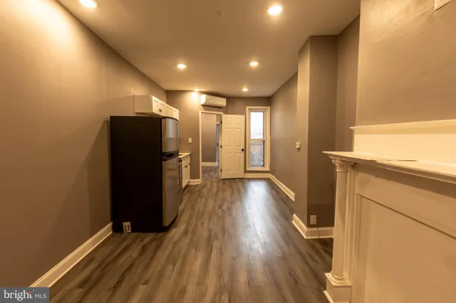 a view of hallway with wooden floor