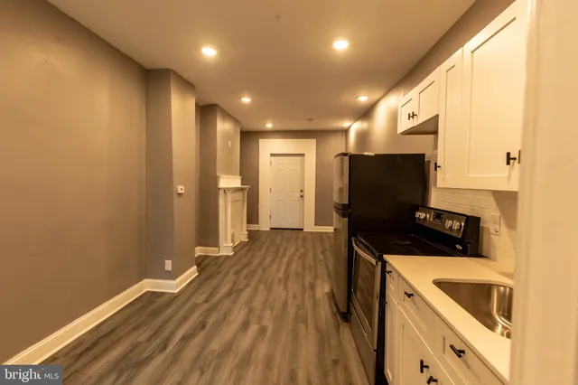 a kitchen with a sink and refrigerator