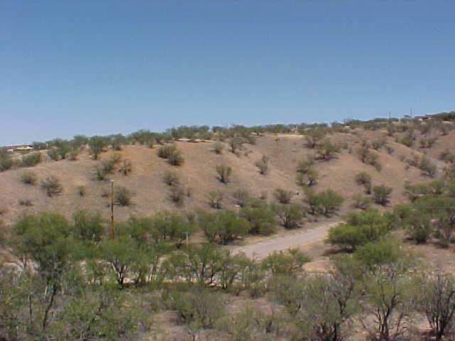 259 Suma Court Rio Rico, AZ 85648 - Photo 1 of 5 an aerial view of a house with a yard and mountain in the back