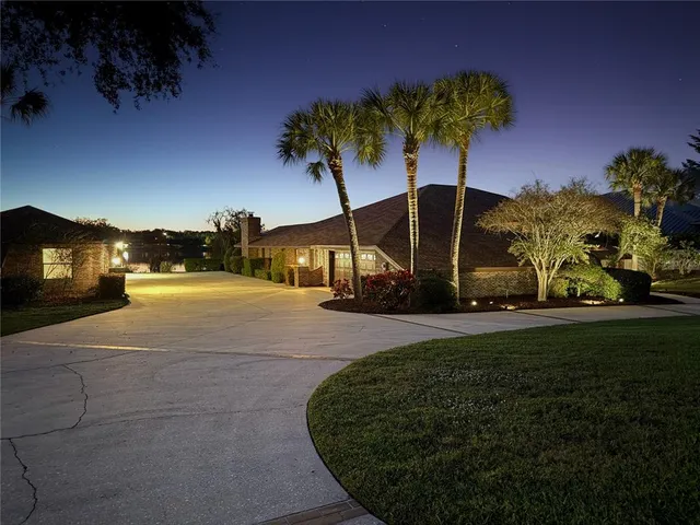 a dining room with furniture large windows a chandelier and a rug