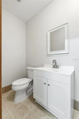 a view of a house with a yard and palm trees