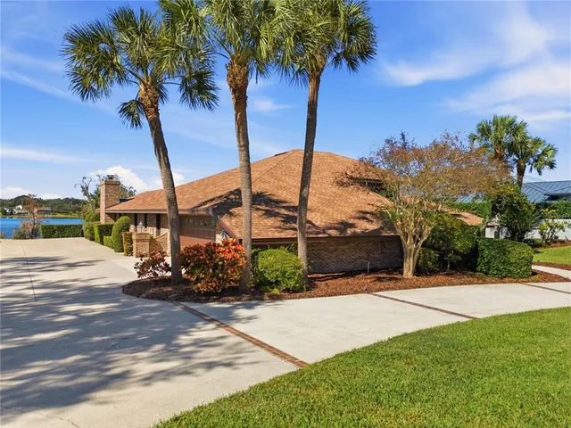 a view of a fountain in front of a house with a big yard