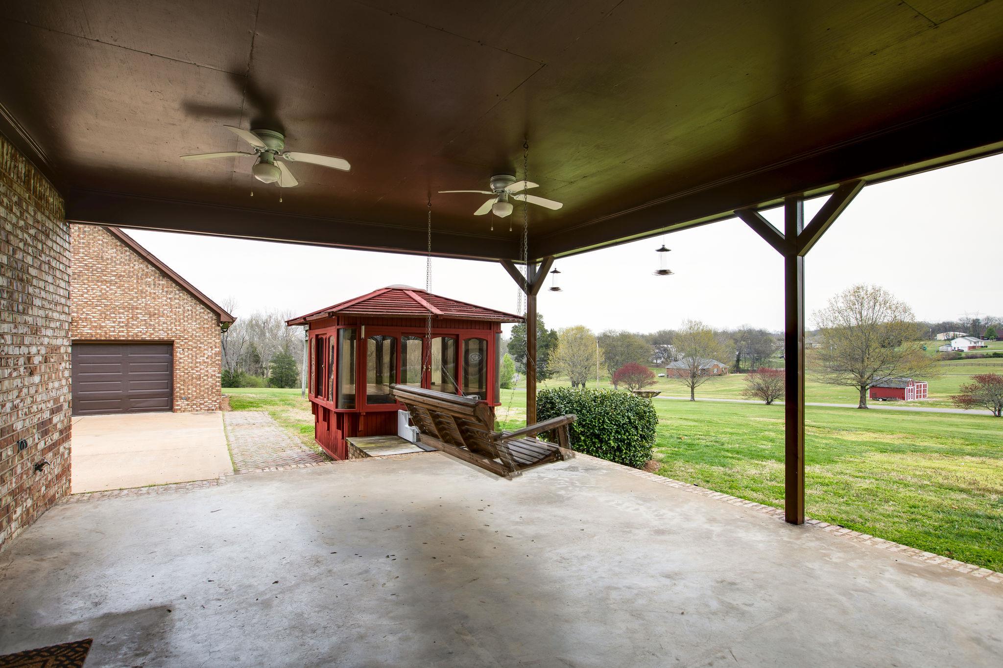 3013 Greens Mill Road Spring Hill, TN 37174 - Photo 26 of 30 This space is outside the family room. Perfect for those rainy days, a morning cup of coffee, or to hang out during a party. The swing and hot tub transfers with the seller.