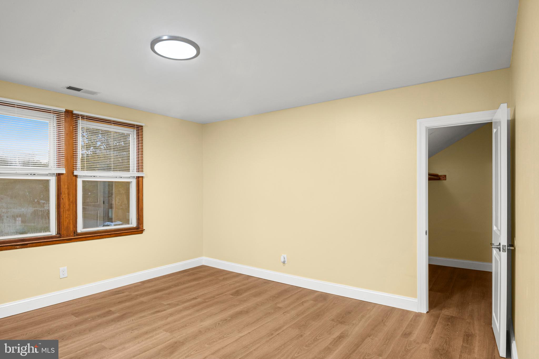 35 3rd Avenue, Unit C Halethorpe, MD 21227 - Photo 13 of 18 a view of an empty room with wooden floor and a window