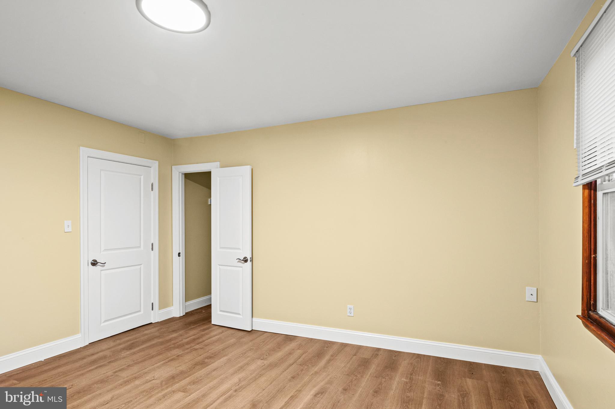 35 3rd Avenue, Unit C Halethorpe, MD 21227 - Photo 14 of 18 a view of an empty room with wooden floor and a window