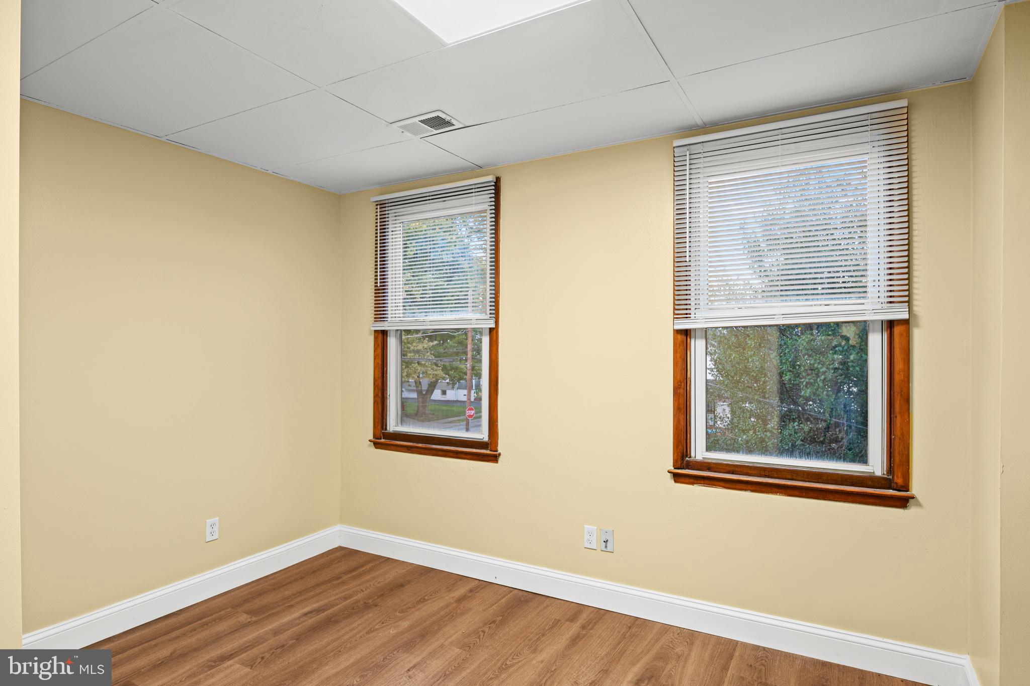 35 3rd Avenue, Unit C Halethorpe, MD 21227 - Photo 15 of 18 a view of an empty room with wooden floor and a window