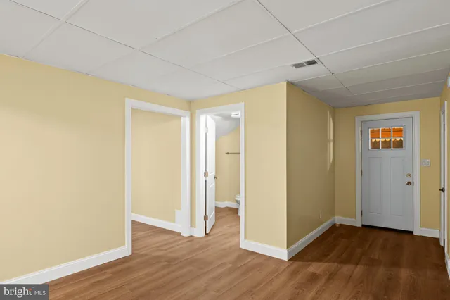 a view of an empty room with wooden floor