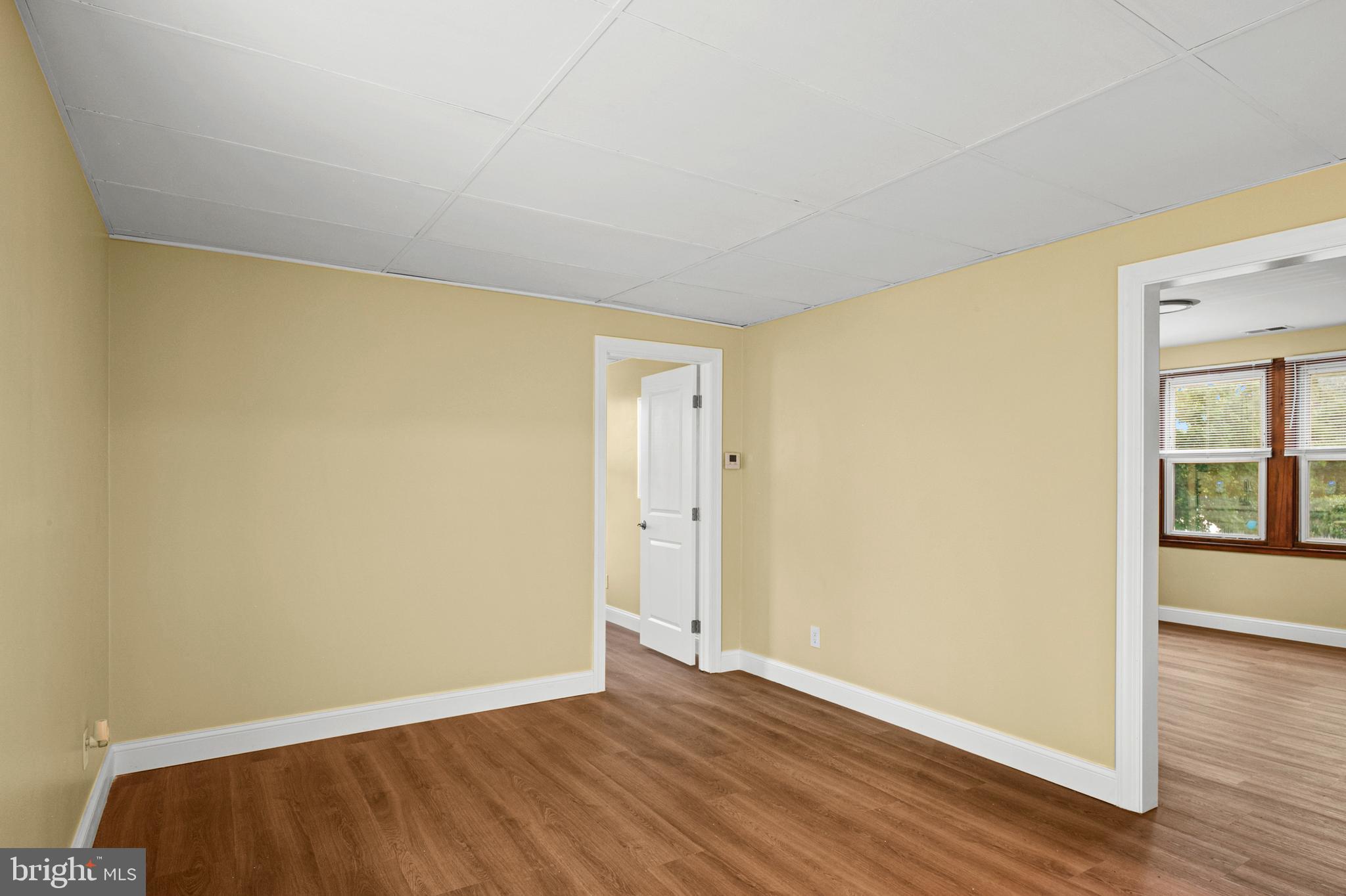 35 3rd Avenue, Unit C Halethorpe, MD 21227 - Photo 3 of 18 a view of an empty room with wooden floor and a window