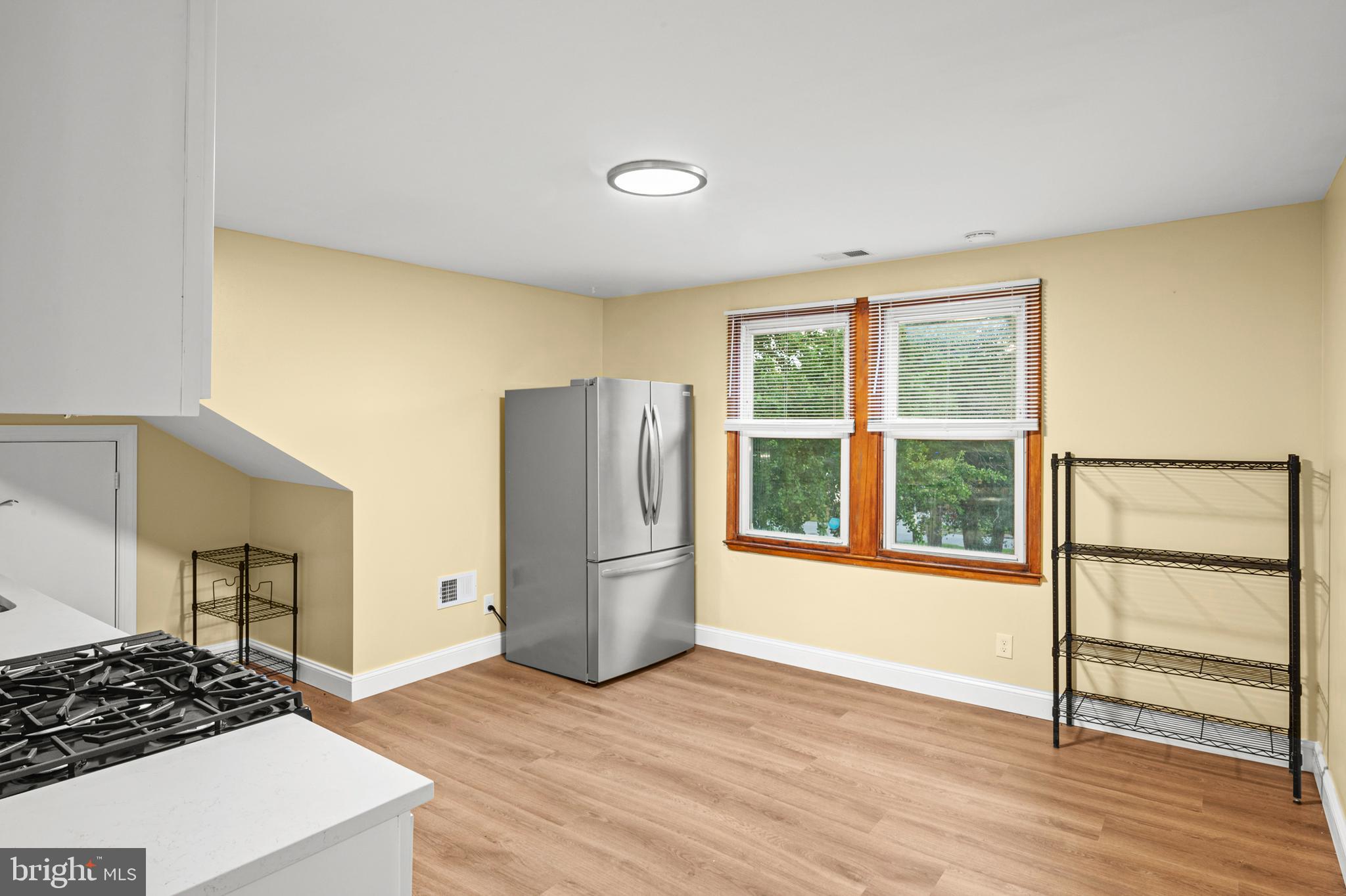 35 3rd Avenue, Unit C Halethorpe, MD 21227 - Photo 5 of 18 an empty room with wooden floor and a window