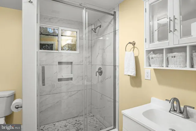 a bathroom with a sink toilet and shower