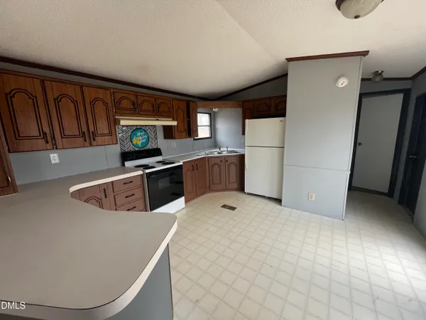 a kitchen with a refrigerator sink and stove
