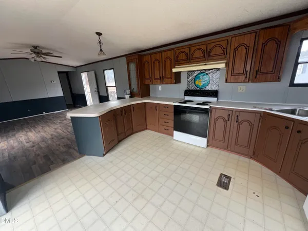 a kitchen with stainless steel appliances granite countertop a sink dishwasher stove top oven and cabinets