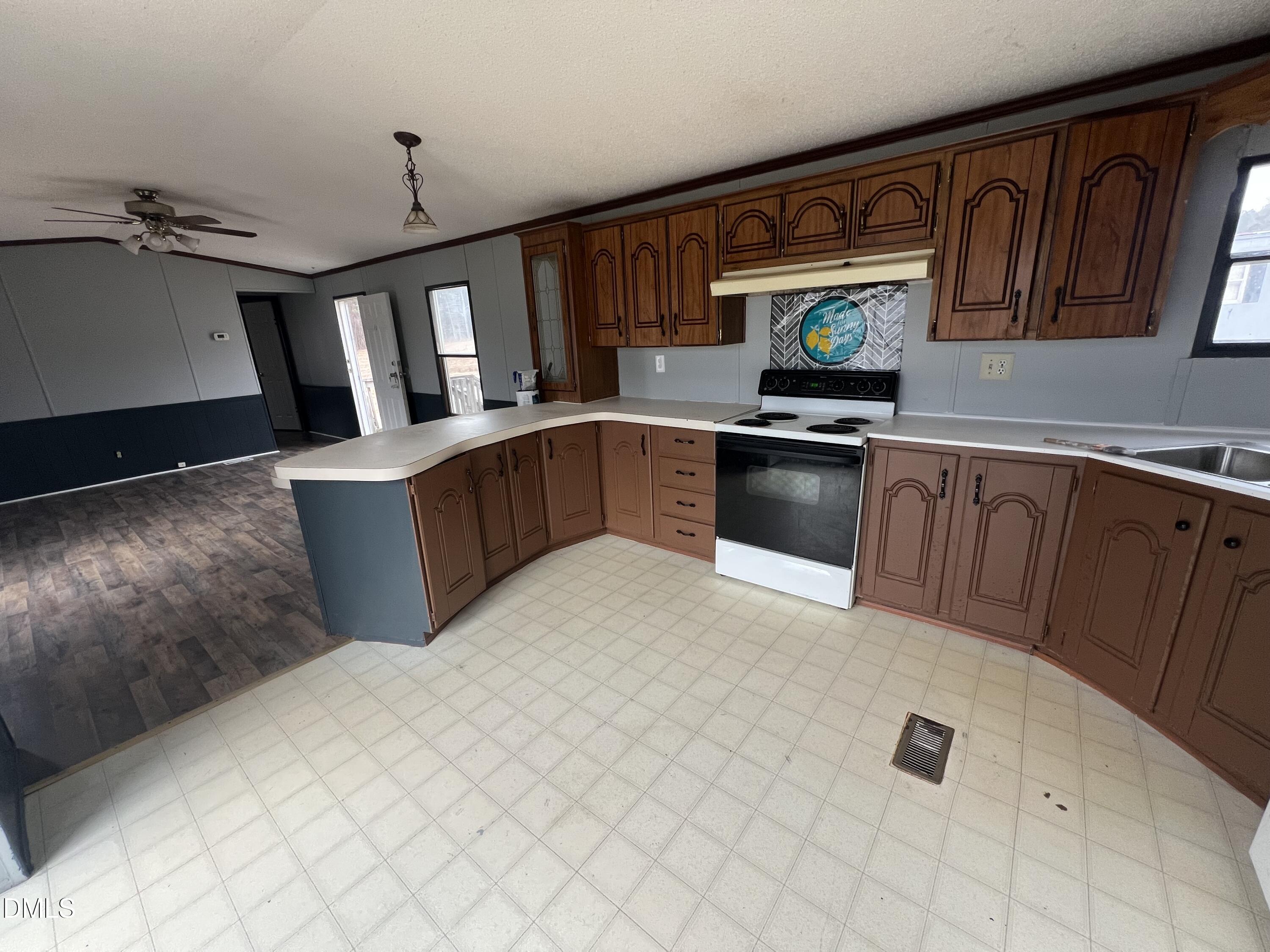 172 Pine Forest Loop Louisburg, NC 27549 - Photo 4 of 9 a kitchen with stainless steel appliances granite countertop a sink dishwasher stove top oven and cabinets