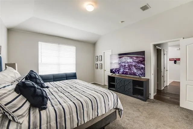 a bedroom with a bed and a couch