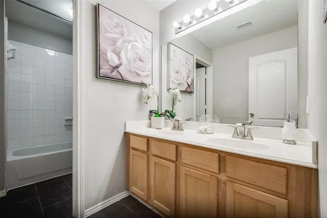 a bathroom with a double vanity sink a mirror and a shower