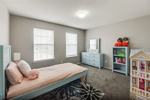 a bedroom with furniture and a window