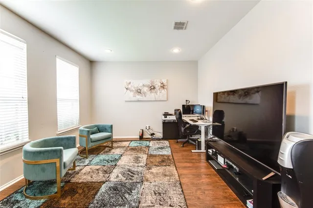 a living room with furniture a rug and a flat screen tv