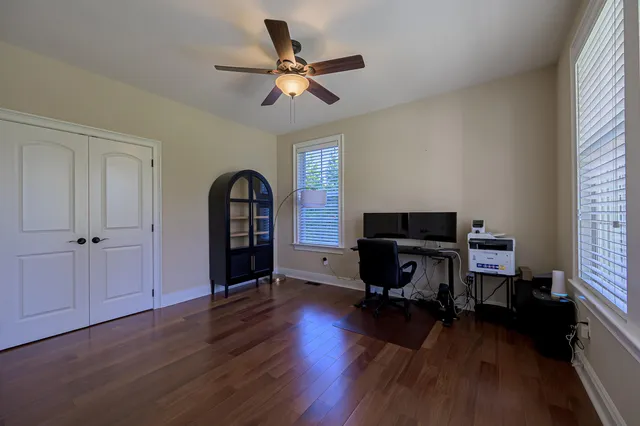 a workspace with wooden floor and a window