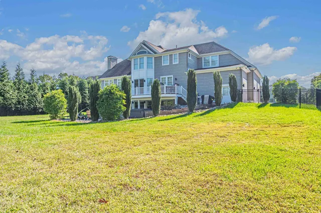 a house view with swimming pool in front of it
