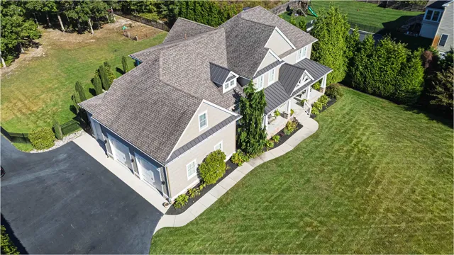 an aerial view of a house with a yard