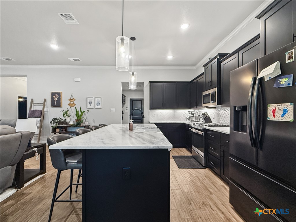 6123 Parma Lane Temple, TX 76502 - Photo 12 of 44 a large kitchen with a table and chairs