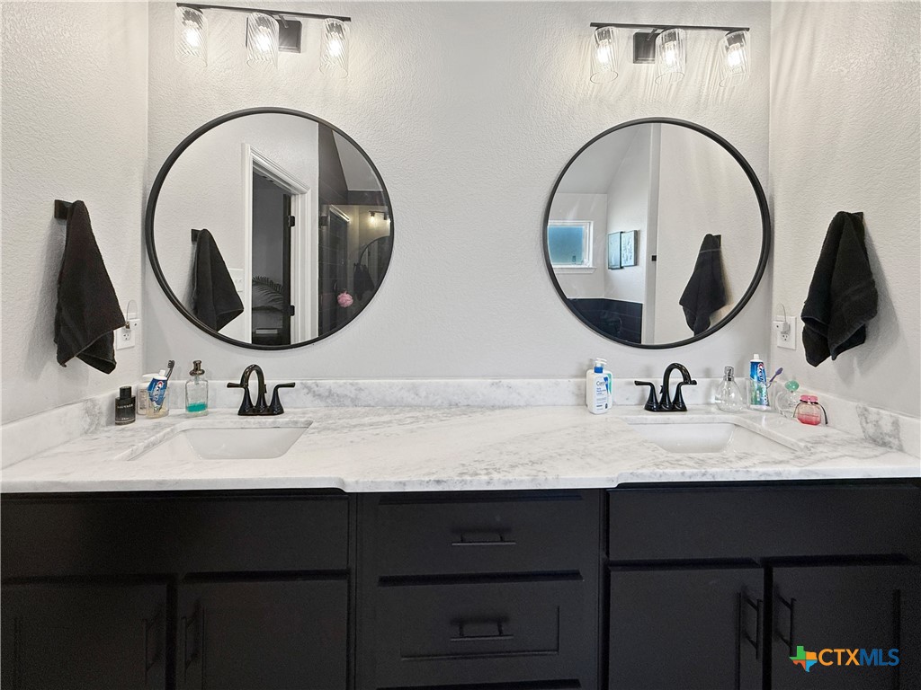 6123 Parma Lane Temple, TX 76502 - Photo 26 of 44 a bathroom with a double vanity sink and a mirror
