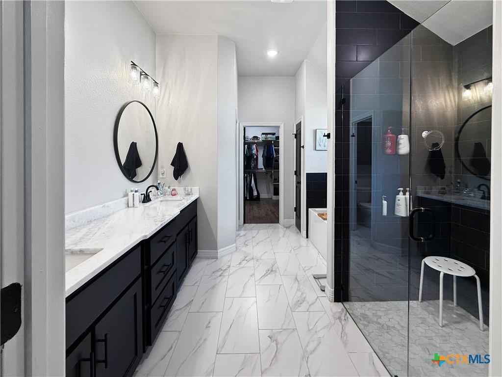 6123 Parma Lane Temple, TX 76502 - Photo 30 of 44 a spacious bathroom with a sink double vanity and a mirror