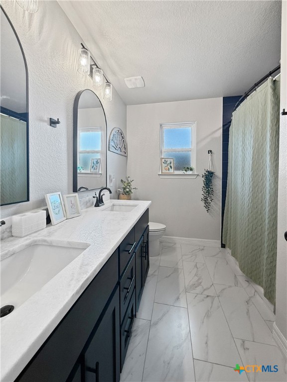 6123 Parma Lane Temple, TX 76502 - Photo 32 of 44 a spacious bathroom with a double vanity sink and a mirror