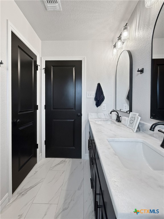 6123 Parma Lane Temple, TX 76502 - Photo 33 of 44 a bathroom with a double vanity sink and a mirror