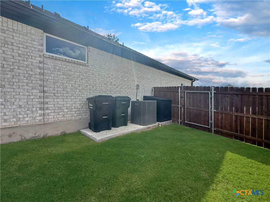 6123 Parma Lane Temple, TX 76502 - Photo 36 of 44 a view of a backyard with potted plants and wooden fence