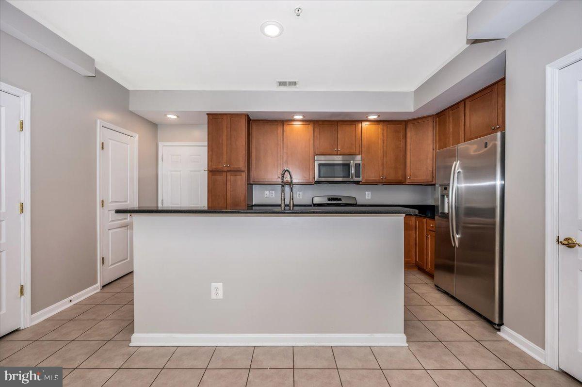 1806 Monocacy View Circle, Unit 41A Frederick, MD 21701 - Photo 13 of 59 a kitchen with kitchen island a counter top space cabinets and stainless steel appliances