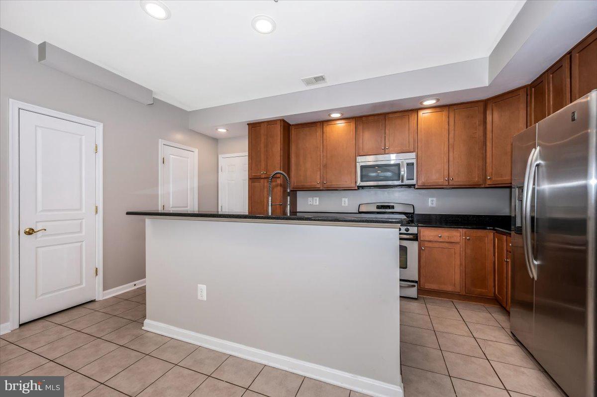 1806 Monocacy View Circle, Unit 41A Frederick, MD 21701 - Photo 14 of 59 a kitchen with stainless steel appliances granite countertop a refrigerator and a stove top oven