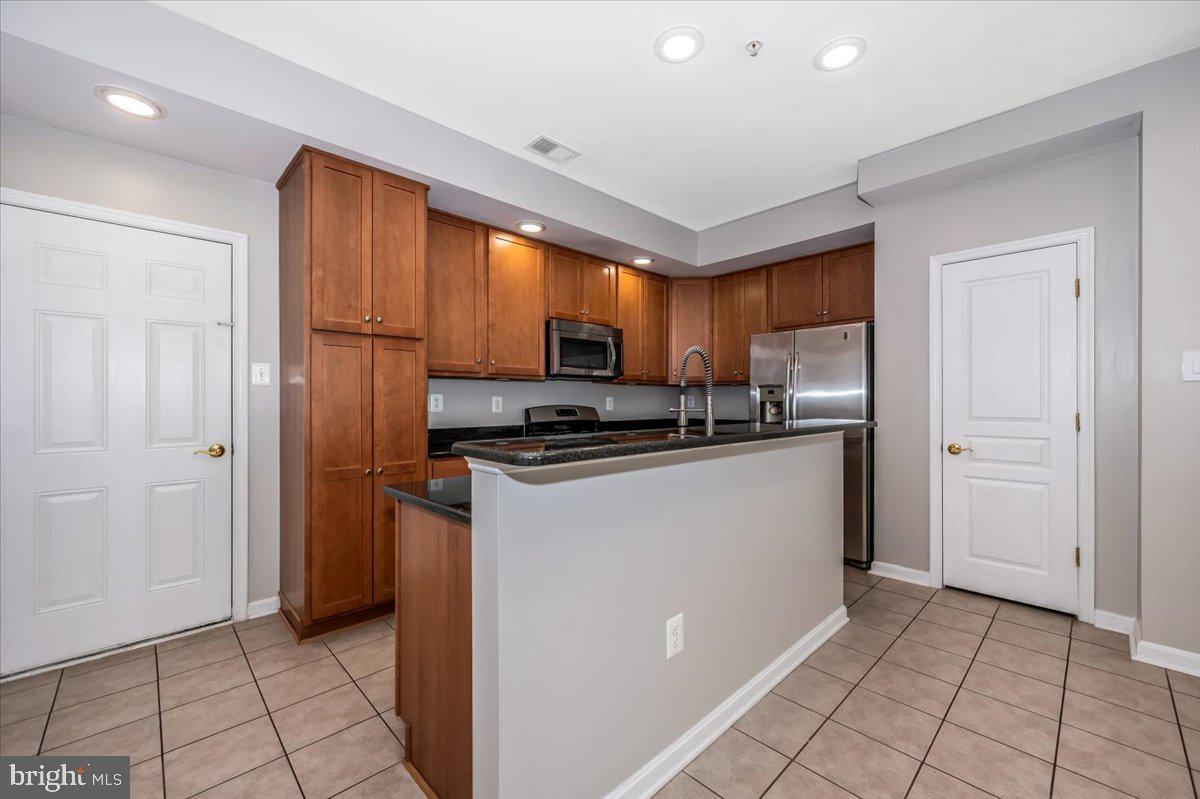 1806 Monocacy View Circle, Unit 41A Frederick, MD 21701 - Photo 15 of 59 a kitchen with stainless steel appliances a refrigerator and a stove top oven