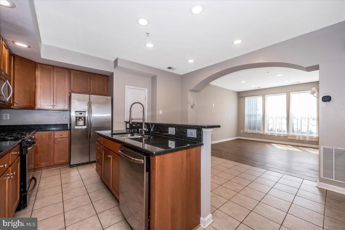 1806 Monocacy View Circle, Unit 41A Frederick, MD 21701 - Photo 17 of 59 a kitchen with granite countertop a stove sink and cabinets
