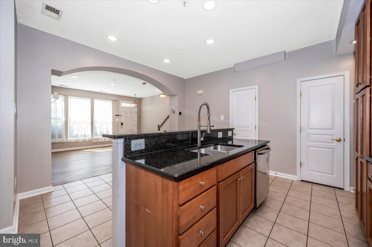 1806 Monocacy View Circle, Unit 41A Frederick, MD 21701 - Photo 19 of 59 a kitchen with granite countertop a stove and a sink