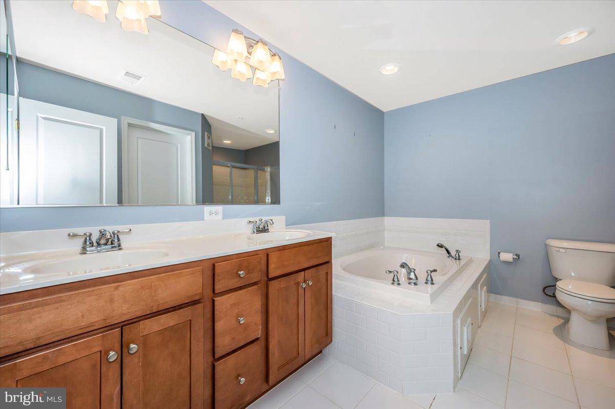 1806 Monocacy View Circle, Unit 41A Frederick, MD 21701 - Photo 30 of 59 a bathroom with a tub sink and mirror