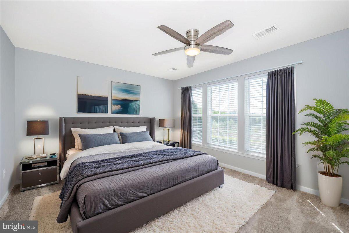 1806 Monocacy View Circle, Unit 41A Frederick, MD 21701 - Photo 37 of 59 a bedroom with a large bed and a potted plant