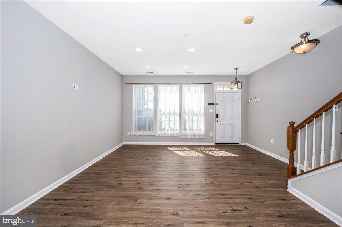 1806 Monocacy View Circle, Unit 41A Frederick, MD 21701 - Photo 5 of 59 a view of an empty room with wooden floor and a window