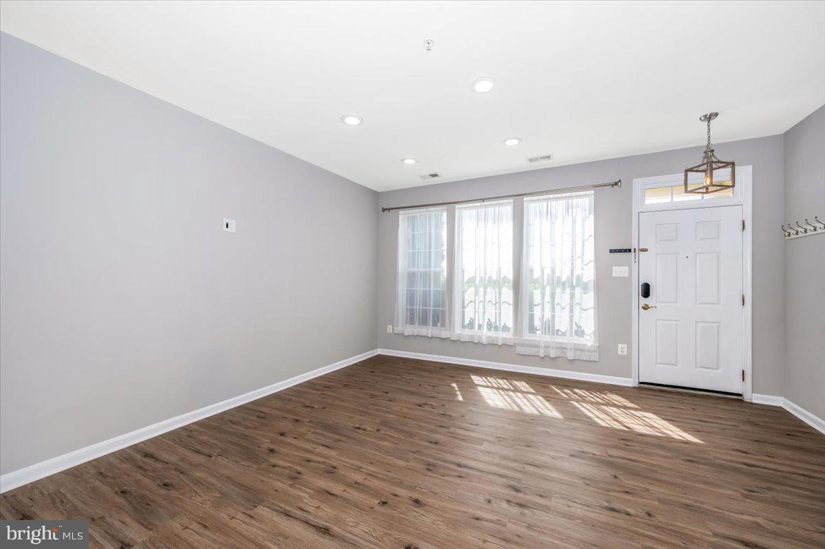 1806 Monocacy View Circle, Unit 41A Frederick, MD 21701 - Photo 6 of 59 a view of an empty room with wooden floor and a window