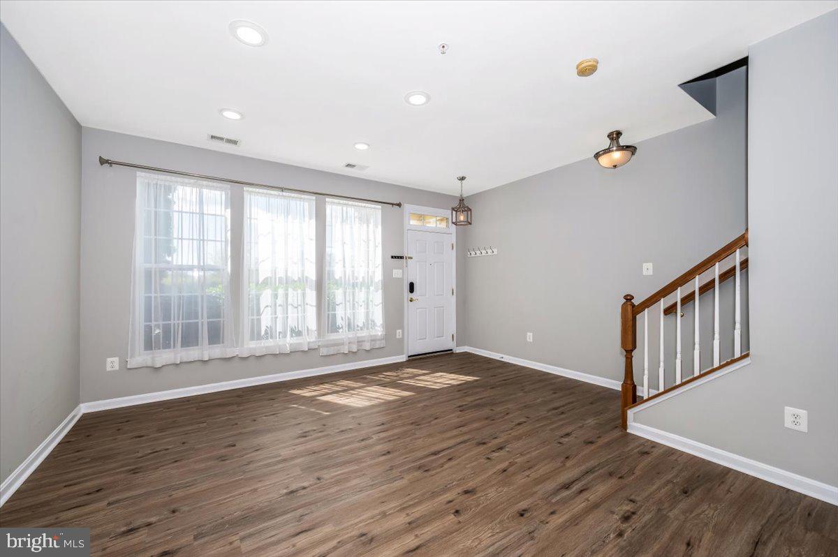 1806 Monocacy View Circle, Unit 41A Frederick, MD 21701 - Photo 7 of 59 a view of an empty room with wooden floor and a window