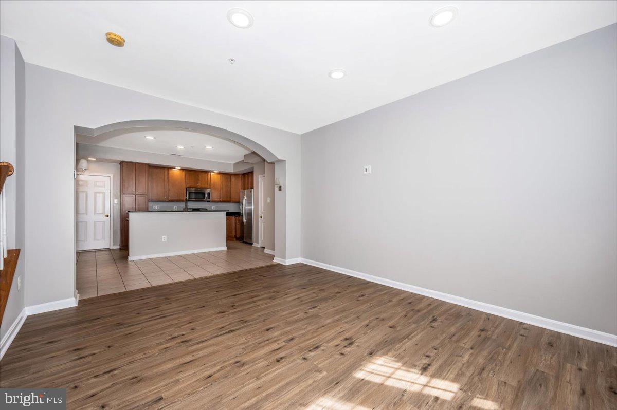 1806 Monocacy View Circle, Unit 41A Frederick, MD 21701 - Photo 9 of 59 a view of a room with wooden floor and a kitchen
