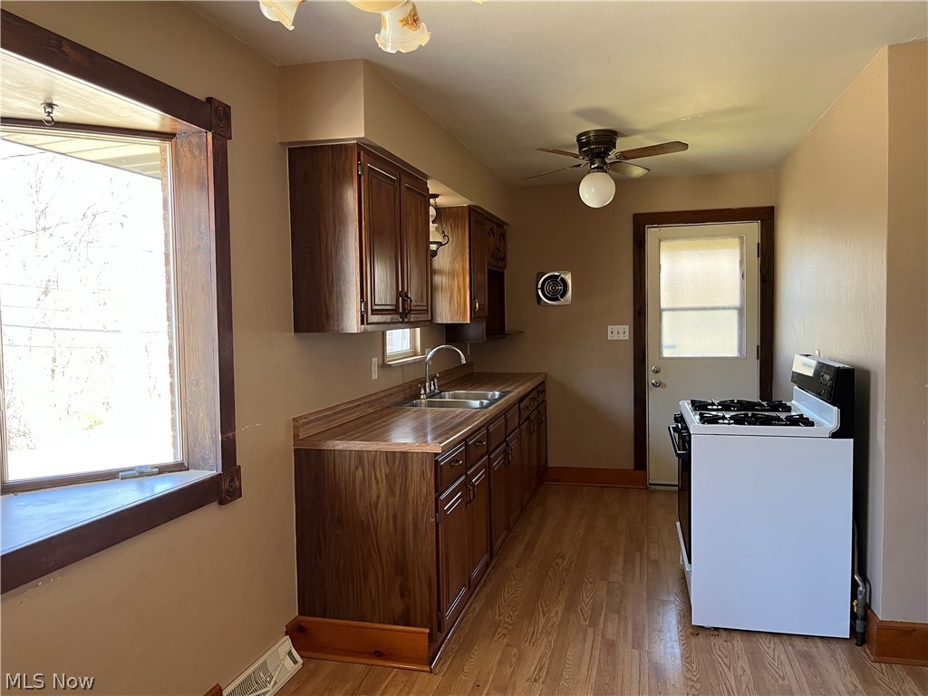 182 Culler Road Weirton, WV 26062 - Photo 8 of 23 Kitchen featuring sink, gas range, light wood-style floors, and ceiling fan