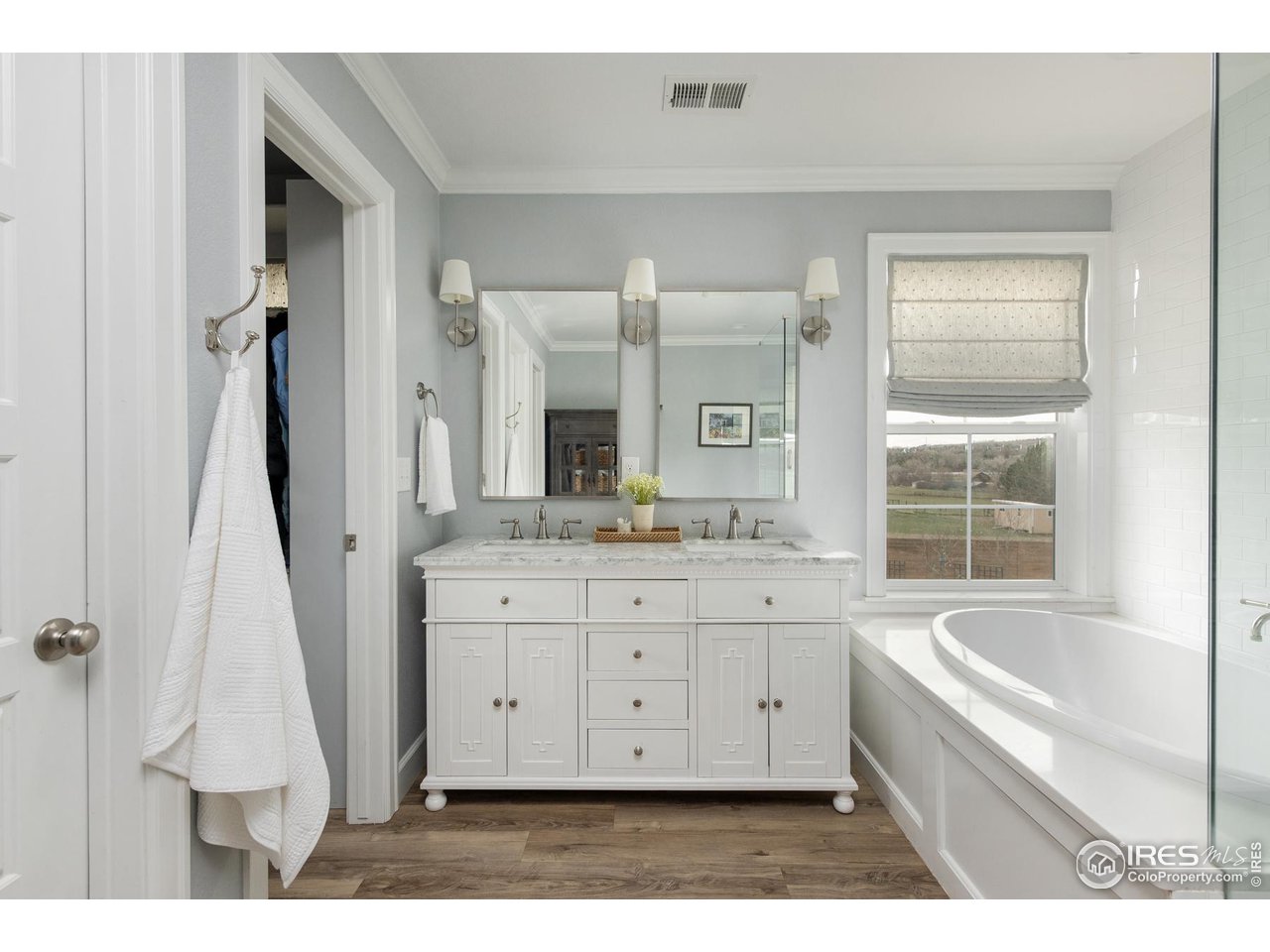 6685 Baseline Road Boulder, CO 80303 - Photo 26 of 38 a bathroom with a granite countertop sink a mirror and a bathtub
