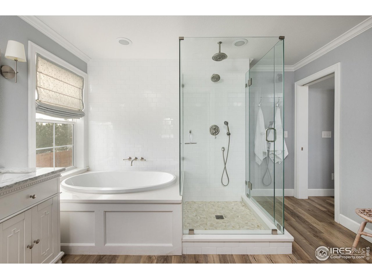 6685 Baseline Road Boulder, CO 80303 - Photo 27 of 38 a bathroom with a sink a toilet a glass door shower and a mirror