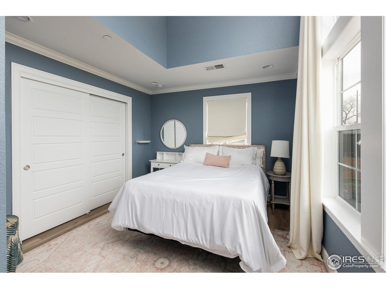 6685 Baseline Road Boulder, CO 80303 - Photo 28 of 38 a bedroom with a bed and a large mirror