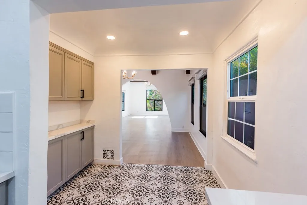 128 South Harper Avenue, Unit 130 Los Angeles, CA 90048 - Photo 13 of 43 a view of a hallway to kitchen and wooden floor