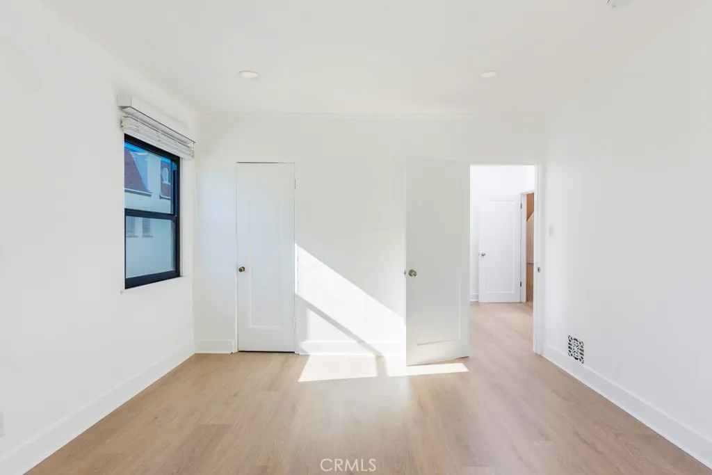 128 South Harper Avenue, Unit 130 Los Angeles, CA 90048 - Photo 24 of 43 a view of an empty room with wooden floor