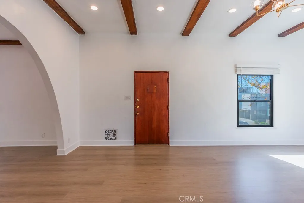 128 South Harper Avenue, Unit 130 Los Angeles, CA 90048 - Photo 34 of 43 a view of an empty room with wooden floor and a window