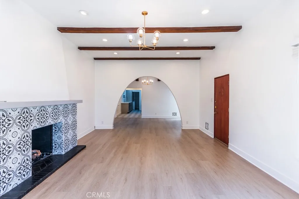128 South Harper Avenue, Unit 130 Los Angeles, CA 90048 - Photo 6 of 43 a view of empty room with wooden floor and fireplace
