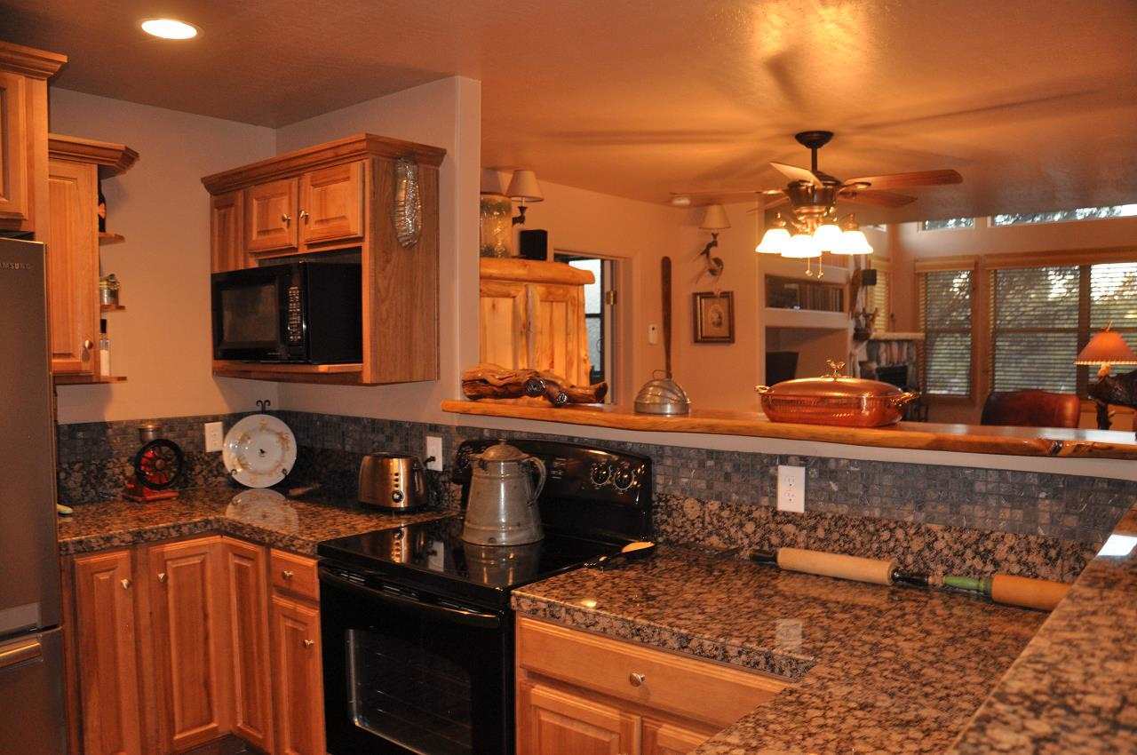 2253 Cross Country Road Overgaard, AZ 85933 - Photo 26 of 33 a kitchen with a sink and a stove